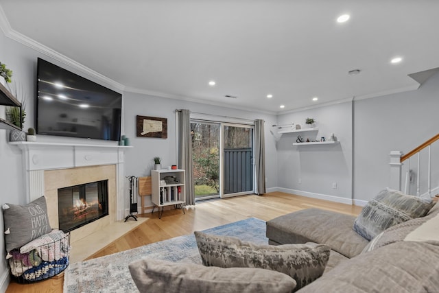 living room with ornamental molding, recessed lighting, wood finished floors, and a premium fireplace