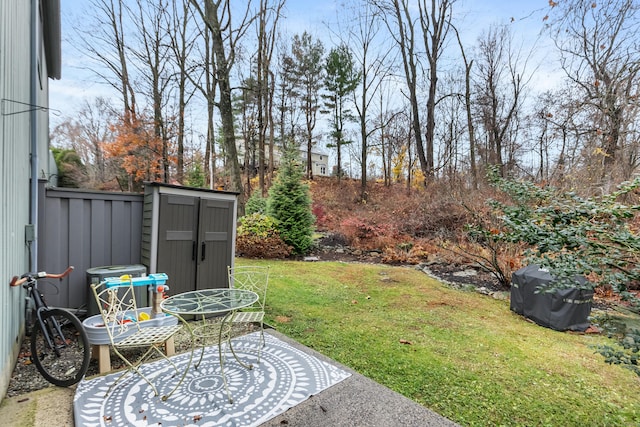 view of yard with an outbuilding, a storage shed, and central AC unit