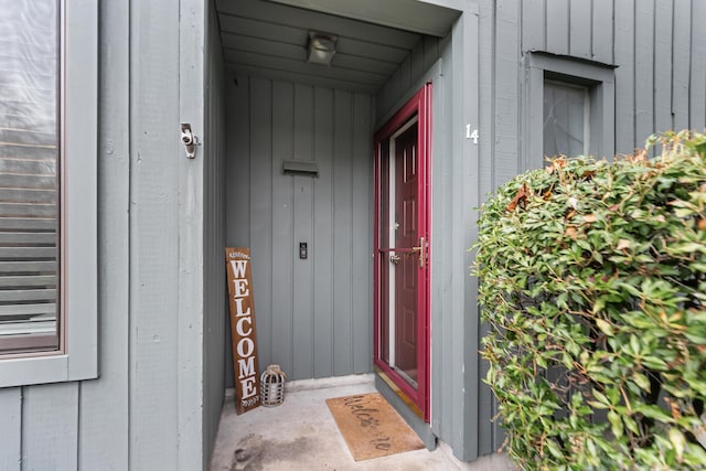 property entrance featuring board and batten siding