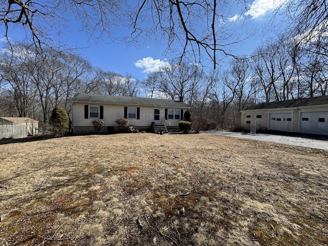 view of front of house featuring crawl space and an outdoor structure