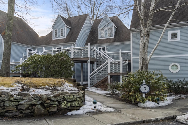 313 Old Pond Ln Unit 313, Norwich, CT 06360 - view of front of property with a wooden deck, stairway, and roof with shingles