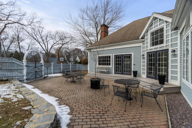 313 Old Pond Ln Unit 313, Norwich, CT 06360 - view of patio / terrace featuring french doors, a gate, fence, and outdoor dining area