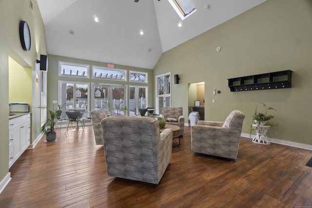 living room featuring a skylight, baseboards, dark wood-type flooring, high vaulted ceiling, and recessed lighting