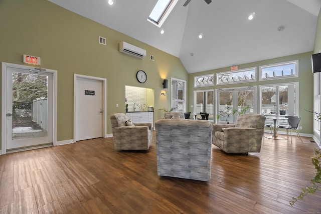 living room featuring a skylight, visible vents, dark wood-style flooring, an AC wall unit, and high vaulted ceiling