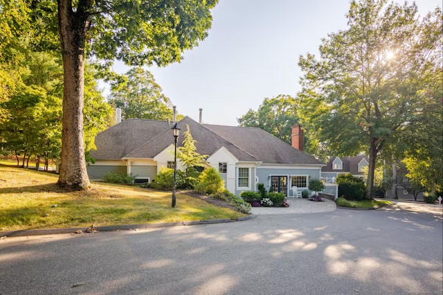 view of front facade with a front lawn and a chimney