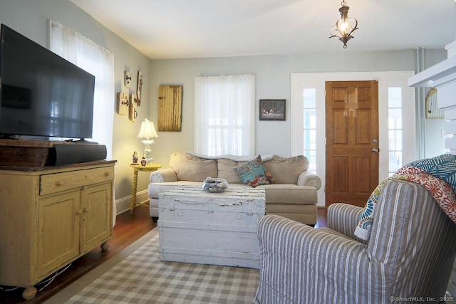 living room with baseboards and wood finished floors