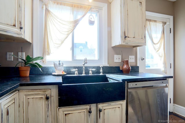 kitchen with a healthy amount of sunlight, dark countertops, and dishwasher