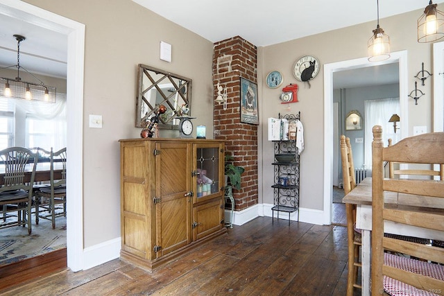 interior space with baseboards and dark wood finished floors