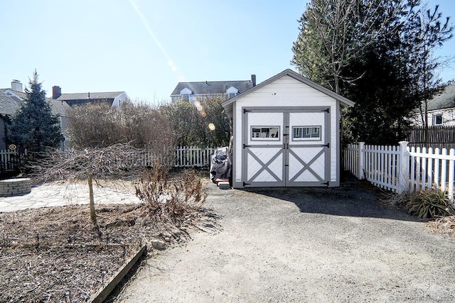 view of shed featuring fence