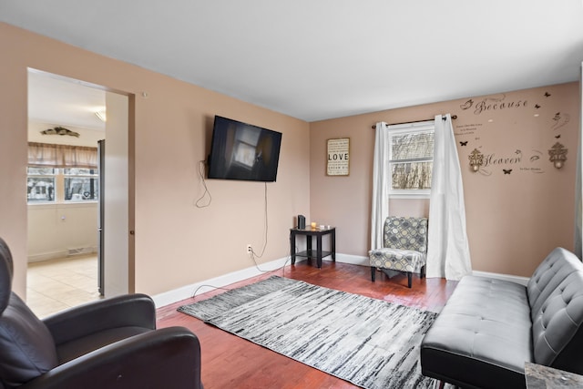 living room with baseboards and wood finished floors