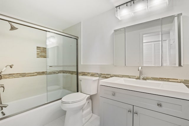 full bathroom with toilet, combined bath / shower with glass door, tile walls, and vanity