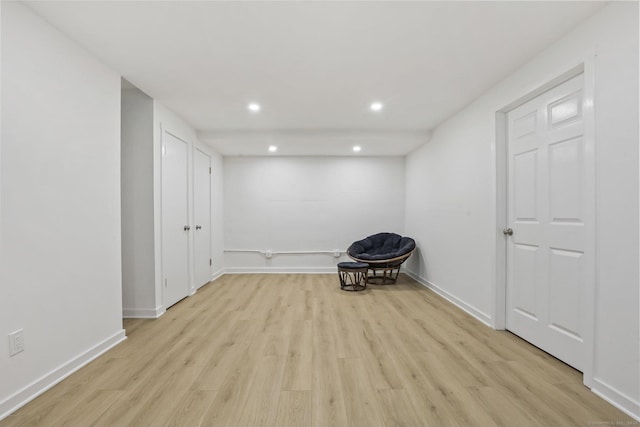 unfurnished room with light wood finished floors, baseboards, and recessed lighting