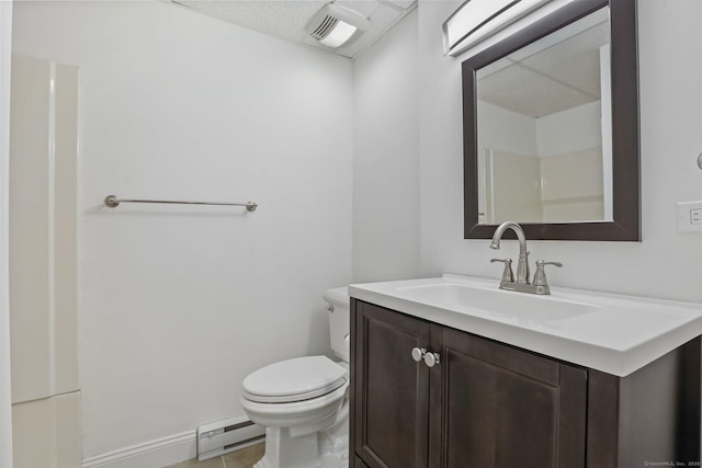 bathroom featuring a baseboard heating unit, vanity, toilet, and baseboards