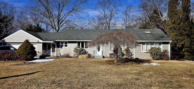 single story home featuring a garage, a front lawn, and roof with shingles