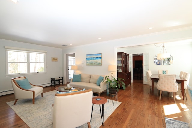 living room featuring ornamental molding, visible vents, and wood finished floors