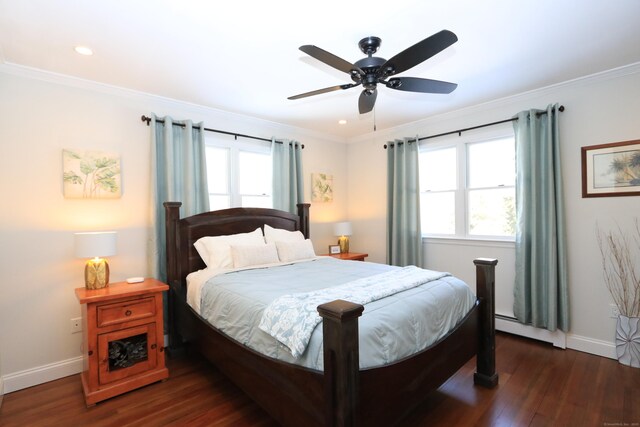 bedroom featuring a baseboard heating unit, multiple windows, ornamental molding, and dark wood-style flooring