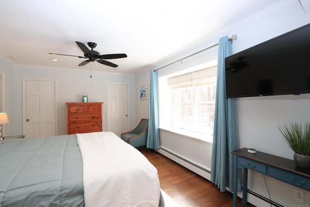bedroom featuring baseboard heating, wood finished floors, ceiling fan, and ornamental molding