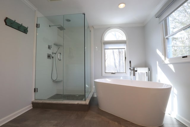 full bath with a freestanding tub, a stall shower, baseboards, and ornamental molding
