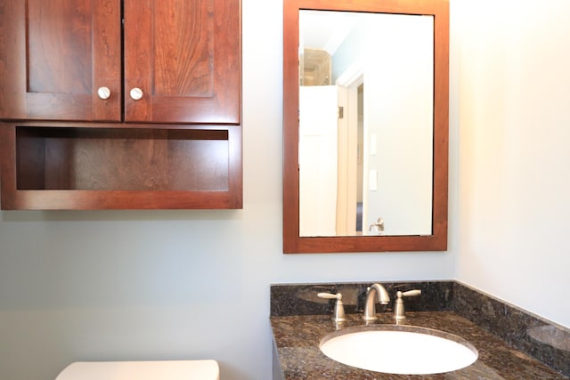 bathroom with toilet and vanity