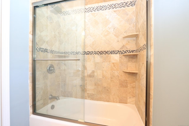 full bath featuring combined bath / shower with glass door