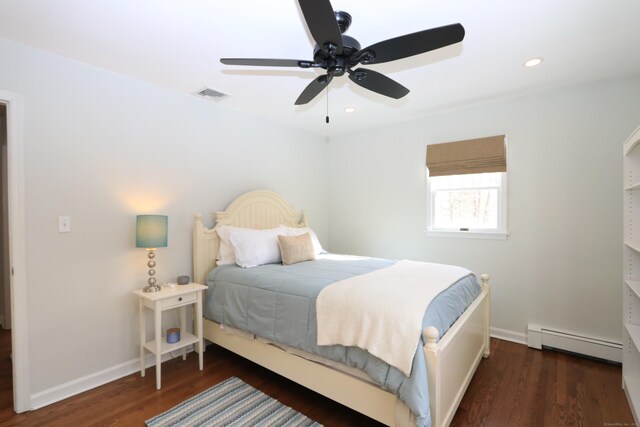 bedroom with a baseboard radiator, recessed lighting, wood finished floors, visible vents, and baseboards