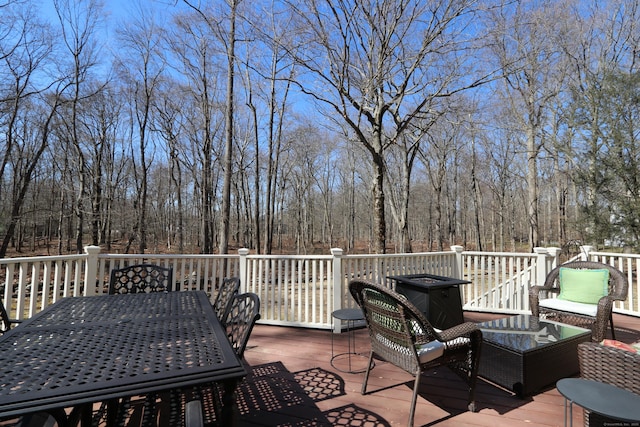 wooden terrace with outdoor dining space and an outdoor living space
