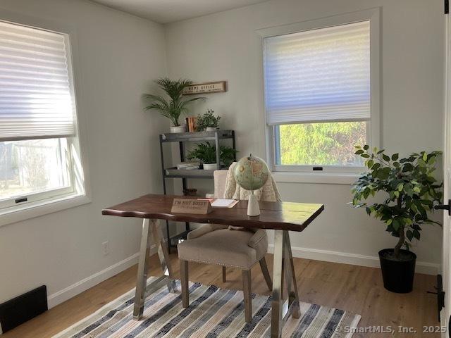 home office featuring baseboards and wood finished floors