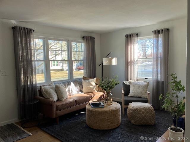 sitting room featuring baseboards and wood finished floors