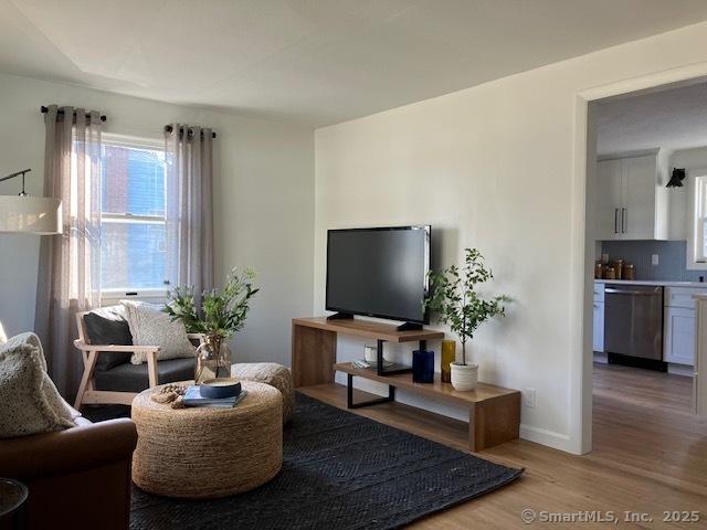 living room featuring light wood-style floors and baseboards