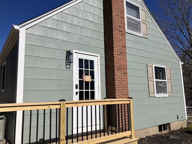 view of side of home featuring a chimney