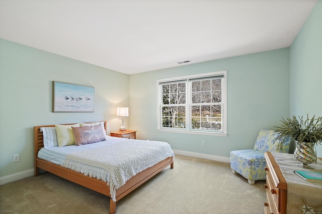 carpeted bedroom featuring visible vents and baseboards