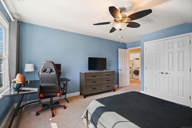 carpeted bedroom with baseboards, washer and clothes dryer, lofted ceiling, ceiling fan, and a closet