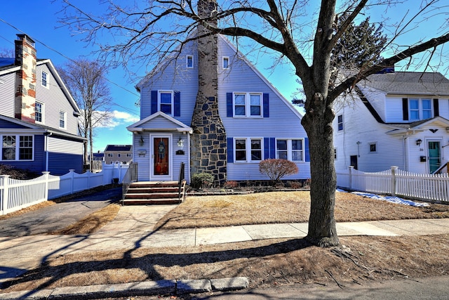 view of front of property featuring fence and a chimney