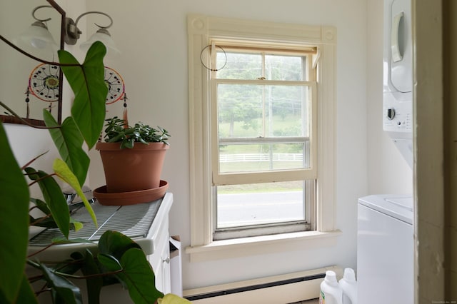 interior space featuring stacked washer / dryer, laundry area, and baseboard heating