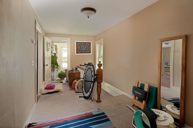 exercise room with carpet floors and baseboards