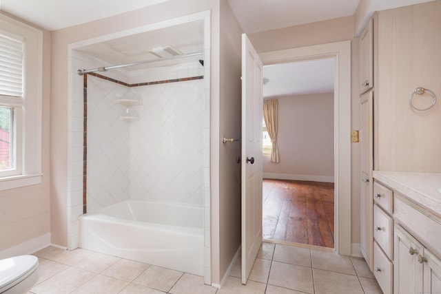 bathroom with baseboards, vanity, toilet, and tile patterned floors