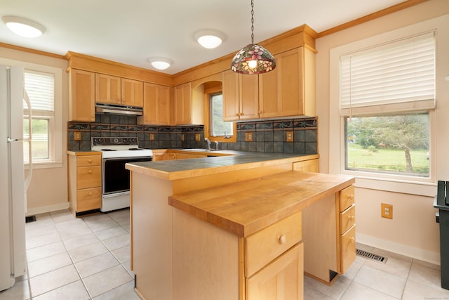 kitchen featuring white appliances, hanging light fixtures, under cabinet range hood, and light brown cabinetry