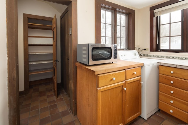 laundry area featuring cabinet space and washer / clothes dryer