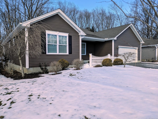 view of front of property featuring a garage and fence