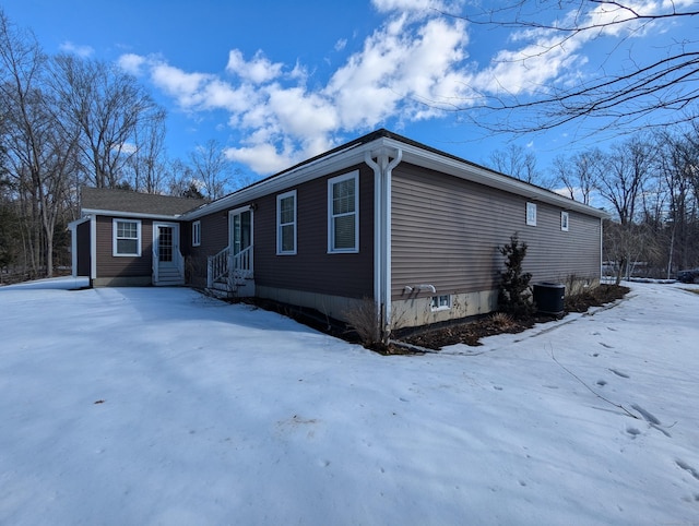 snow covered property featuring entry steps