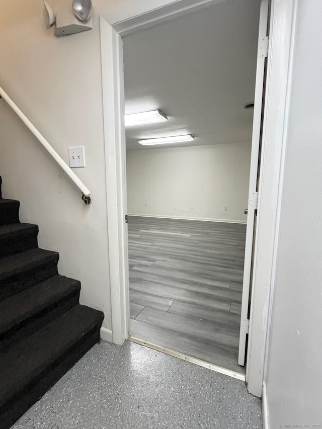 stairs featuring visible vents and speckled floor