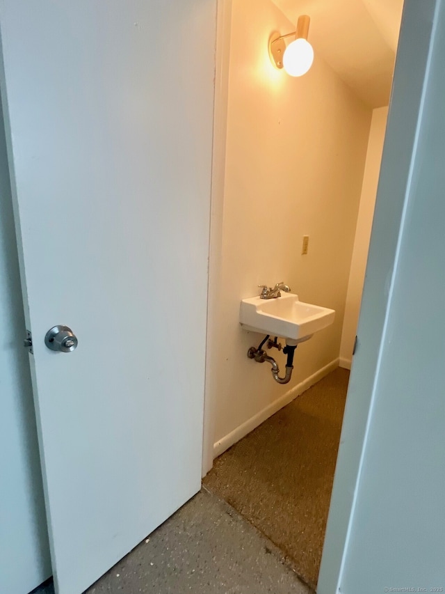 bathroom featuring a sink and speckled floor