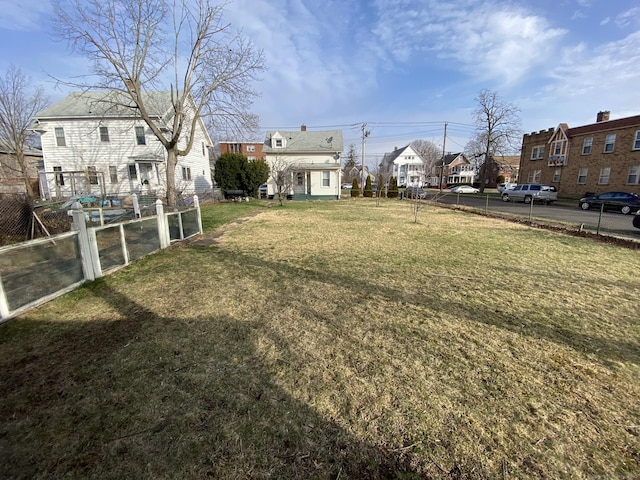 view of yard with a residential view and fence