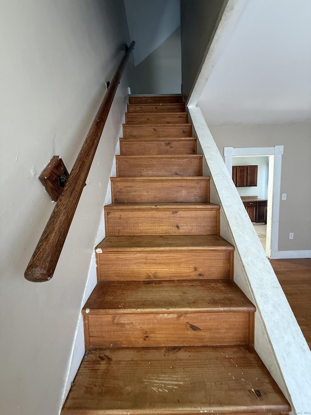 stairs with baseboards and wood finished floors