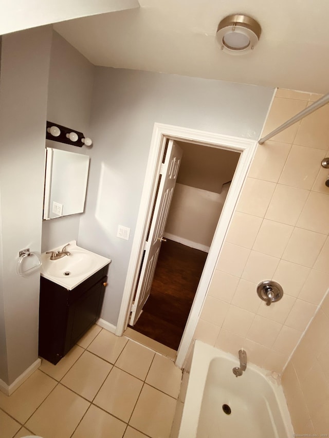 full bathroom featuring shower / bathtub combination, tile patterned flooring, vanity, and baseboards