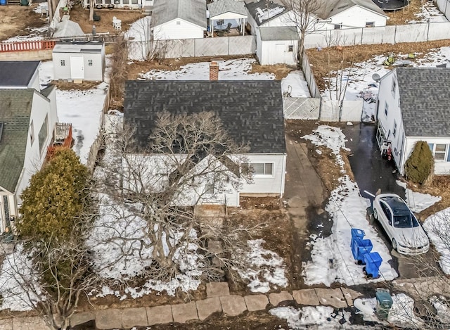 snowy aerial view with a residential view