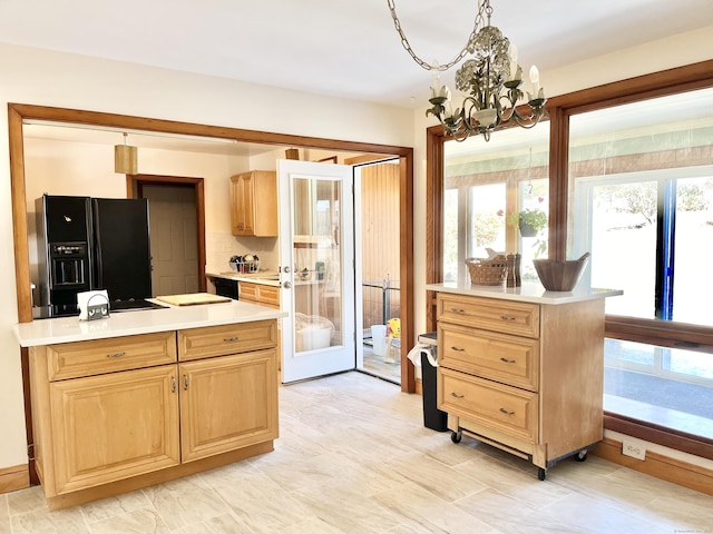 kitchen featuring french doors, light countertops, black fridge with ice dispenser, and light brown cabinets