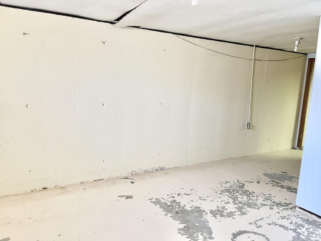 empty room with unfinished concrete flooring