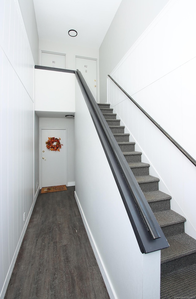 stairs featuring wood finished floors