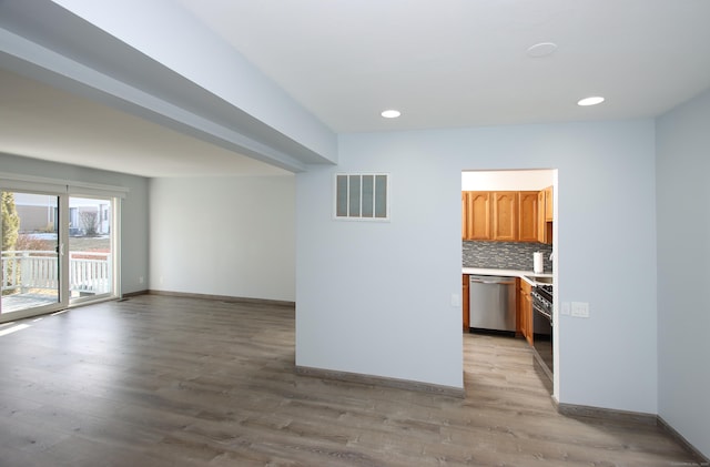 spare room with recessed lighting, visible vents, light wood-style flooring, and baseboards